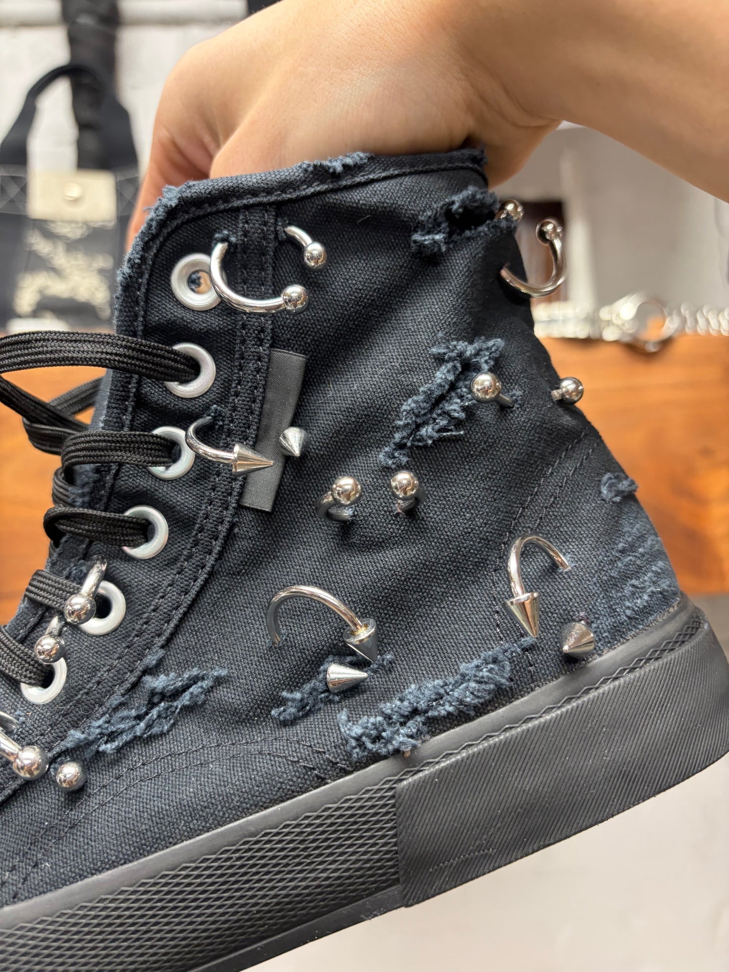 Balenciaga ‘Paris’ Pierced Black Canvas High Top Sneakers