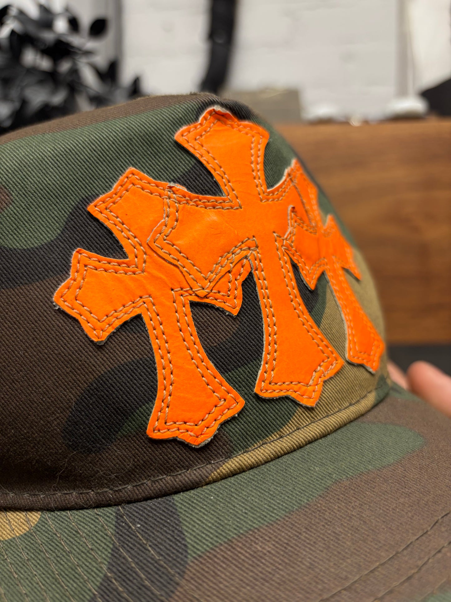 Chrome Hearts Orange ‘Cemetery’ Leather Cross Patch Camo Trucker Hat